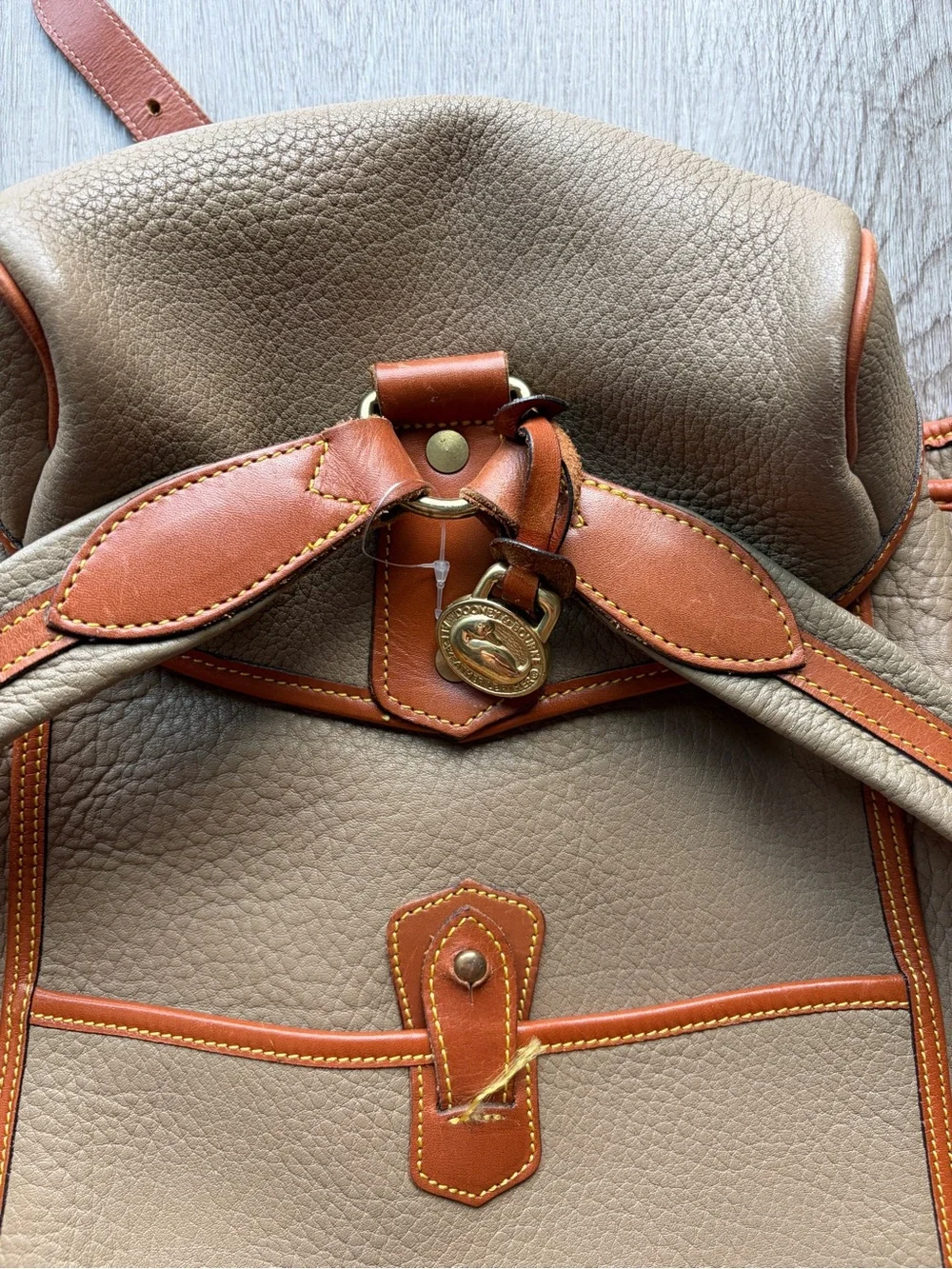 Dooney & Bourke Beige Leather Drawstring Backpack with Tan Trim